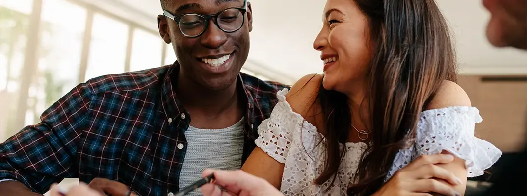 A man and woman meeting with a loan officer.