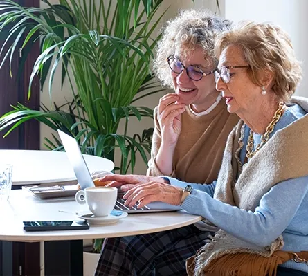 Two women working on a laptop