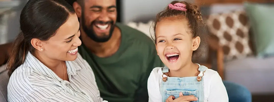 A smiling family of three.