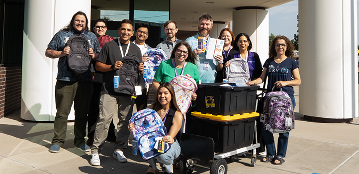 Sunward employees holding donated school supplies