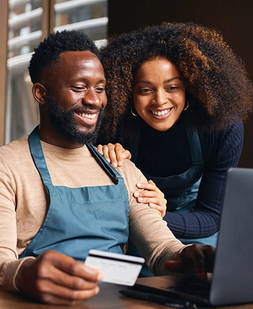 Two diner owners looking at a laptop