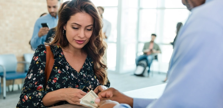 A woman getting cash from a teller.