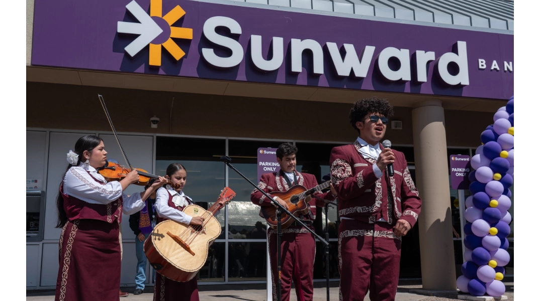 A four-piece mariachi band performing in front of the South Valley branch