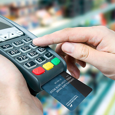 A Sunward debit card being entered into a card processing terminal.