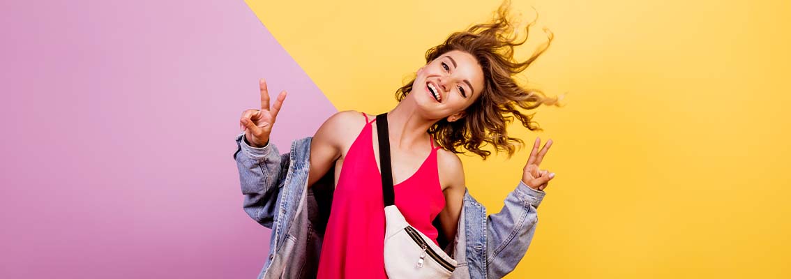 Smiling woman giving the peace sign with both hands