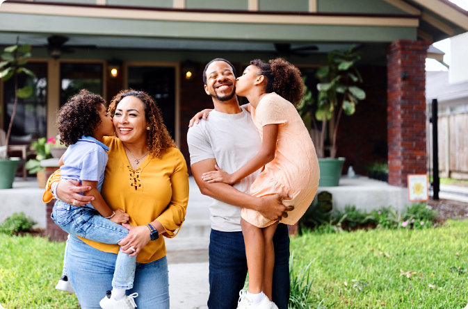 A happy family in front of their home