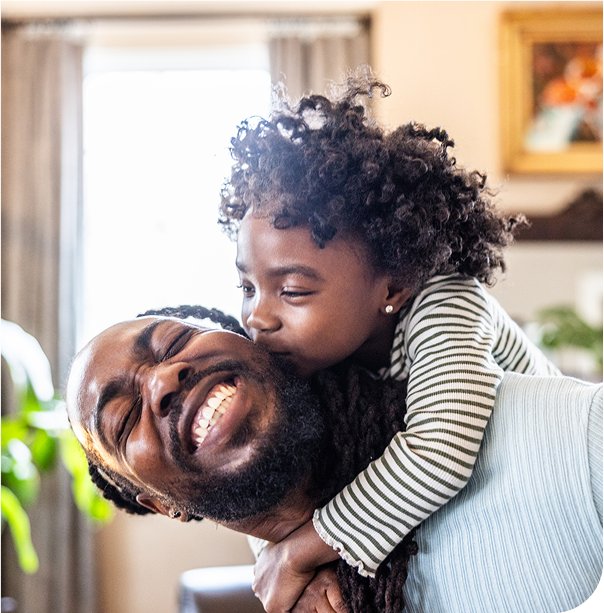 A father giving his daughter a piggyback ride